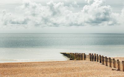 clouds over ocean and sandy beach