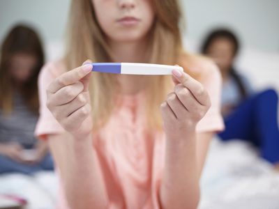 Teenage girl with pregnancy test