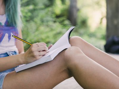 woman writing in gratitude journal