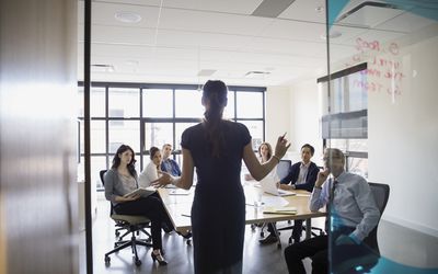 Businesswoman leading meeting in conference room