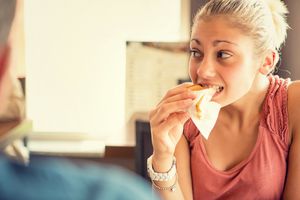 Young woman eat a toast at italian café