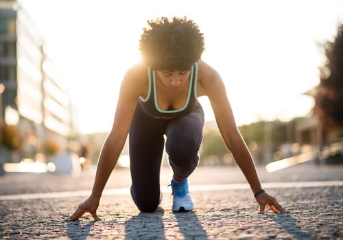 Sprinter woman at start position, Ready to run