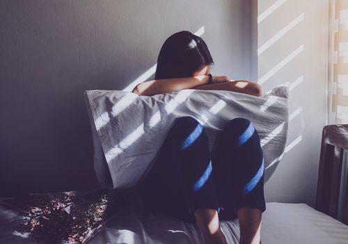 妇女坐床哭泣入枕头
