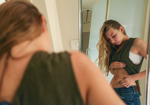 teen girl checking her stomach