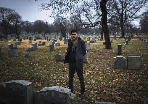 Man visiting graveyard