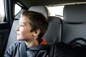 boy (10yrs) looking out car window