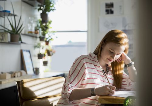 Woman writing in office