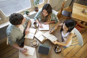 Students sitting at table studying together.
