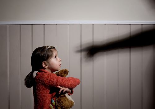 a girl being yelled at by a shadow pointing a finger