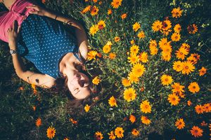 Woman lying in flower patch