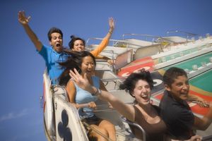 People riding amusement park ride