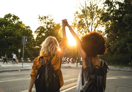 white-woman-BIPOC-woman-solidarity-holding-hands