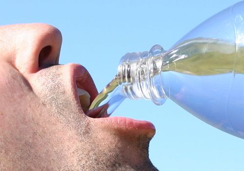 A man drinking water close up