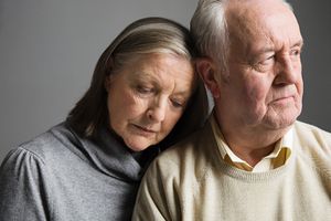 Older man and woman looking sad