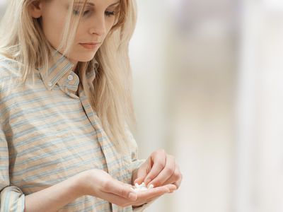 Woman with handful of drugs