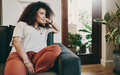 放松在沙发的一个可爱的少妇的播种的射击在家