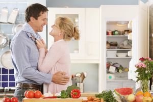 在厨房里准备晚餐的夫妇拥抱