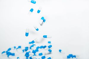 dropping blue and white pills / capsules