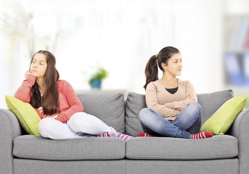 two angry girls on a couch