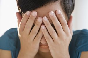 用手蒙住脸的混血妇女