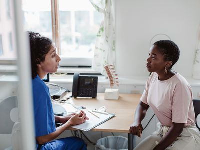 A woman talking to a healthcare provider.