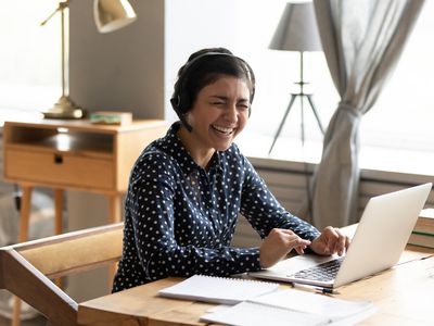 woman laughing during zoom call
