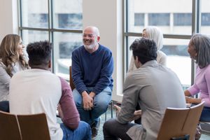 Diverse people sit in circle and brainstorm ideas