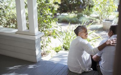 Senior couple hugging on porch
