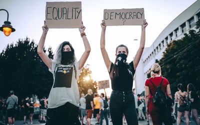 Young women protesters holding placards
