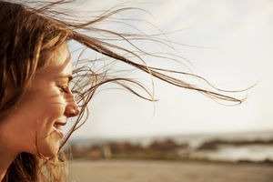 Woman with the wind in her hair smiling