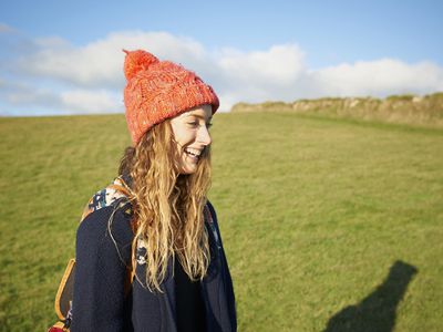 Profile of young woman smiling in countryside