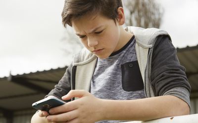 在电话的焦虑的男孩