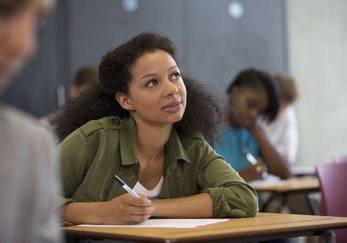 woman thinking while taking exam