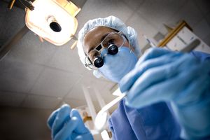 牙医把手伸进病人的嘴里。