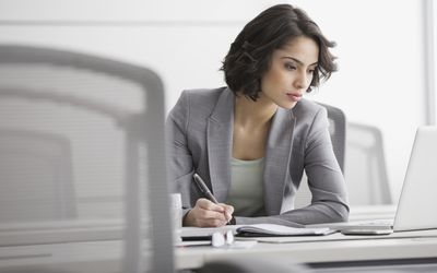Businesswoman working at laptop in conference room