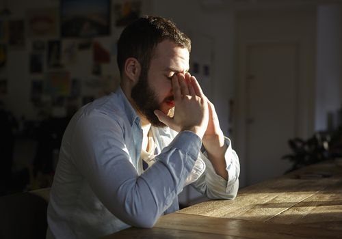 Man sitting at the table looking stressed