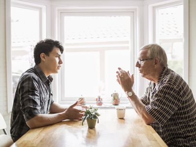 two men having a discussion at the table