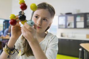 child looking at a molecular model