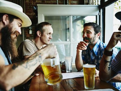 Group of friends sharing drinks in restaurant