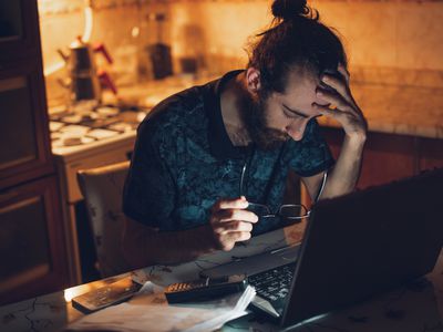man looking upset searching for a job on the computer