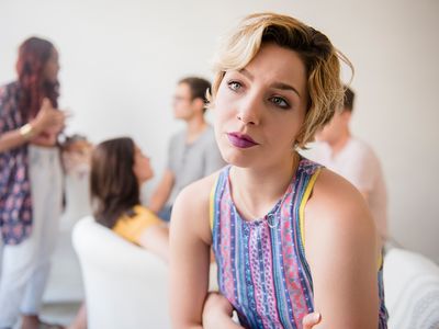 Portrait of woman sulking at party.