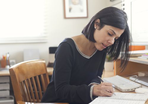 Hispanic woman working in home office