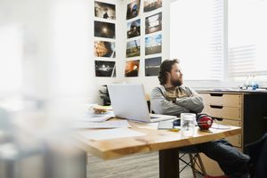 Pensive designer looking out office window