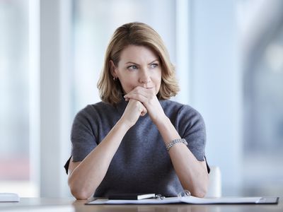 沉思的女商人在会议室里看向别处