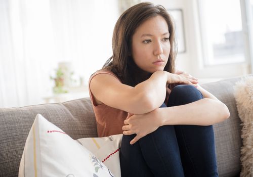 悲哀的混血女人坐在沙发上