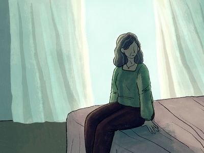 一个女人坐在床上，看着旁边