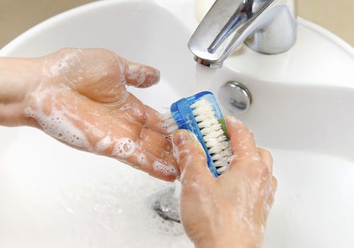 A person with OCD washing their hands