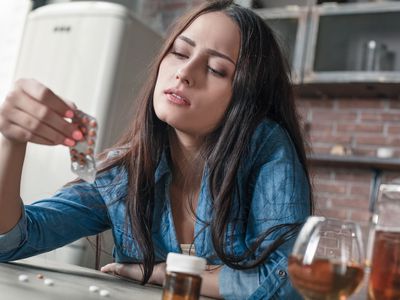 Young woman reading drug label
