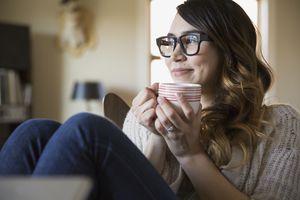 Smiling woman enjoying coffee