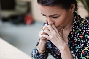 Close-up of tired thoughtful woman with arms